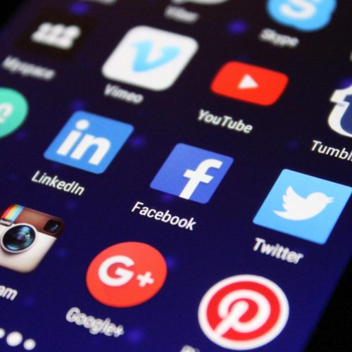 pexels-photo-267350-267350 Close-up of a smartphone screen showing various social media app icons such as Facebook and Twitter.
